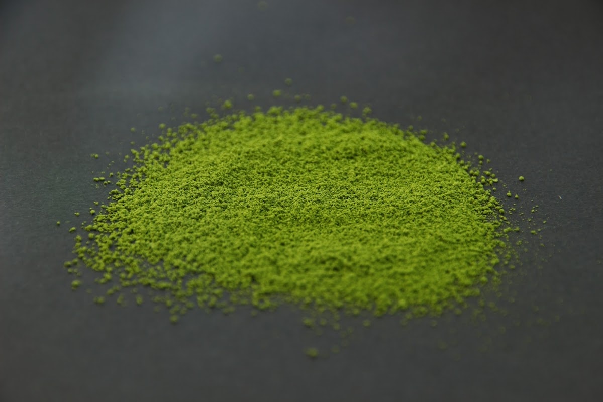 Shizuoka matcha powder heaped on a dark surface