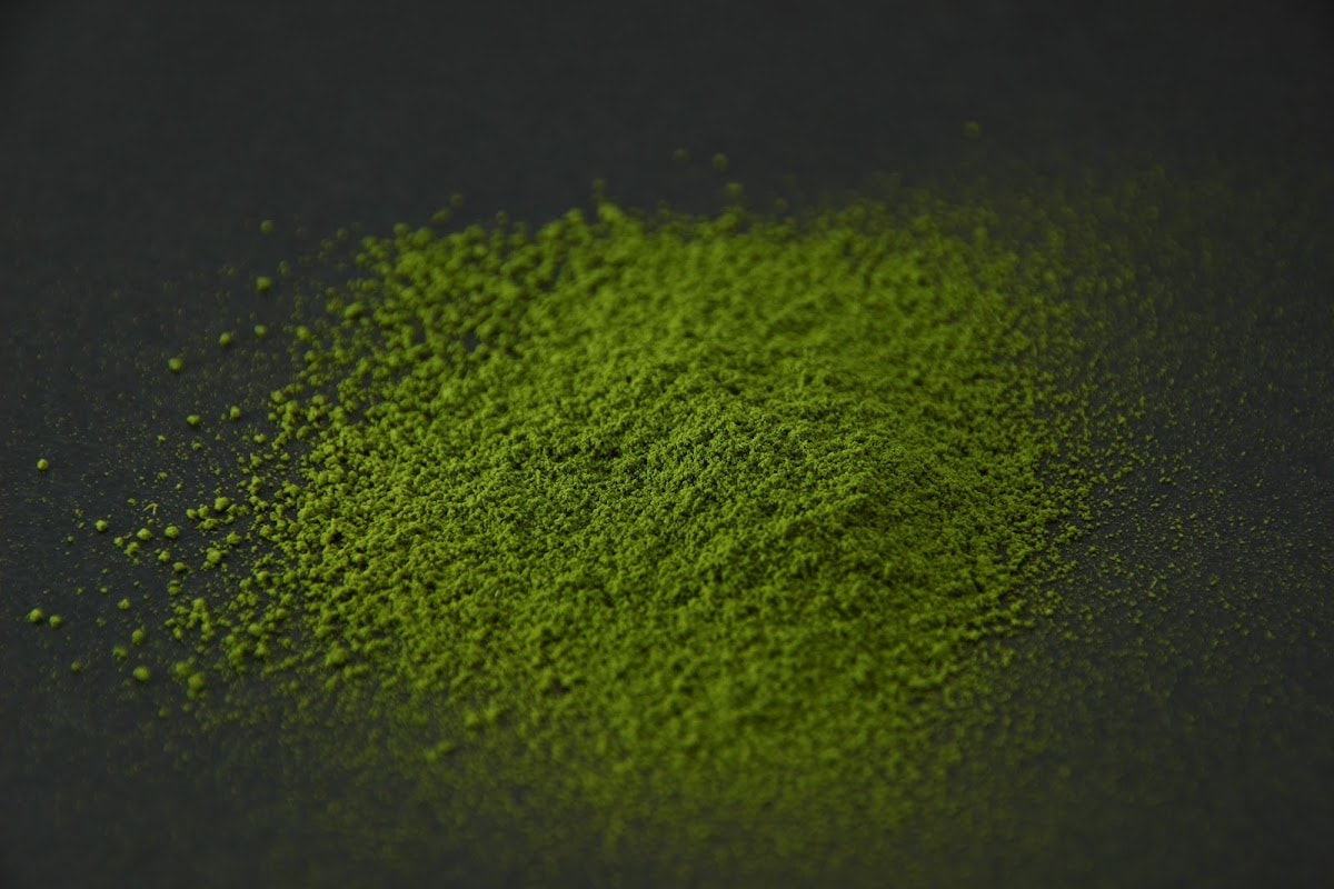 SR-5 matcha powder heaped on a dark surface