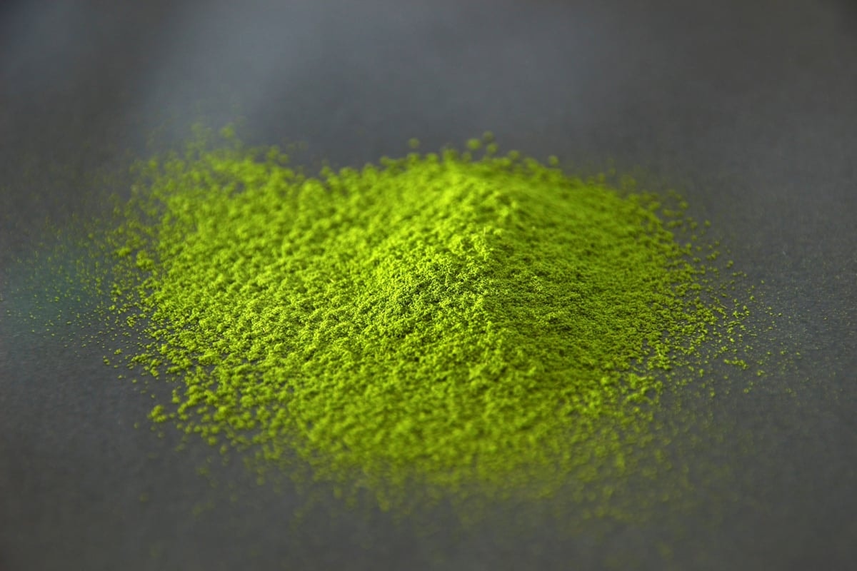Bright green matcha powder from Yame, Fukuoka, heaped on a dark surface